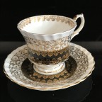 Black with heavy gold trim tea cup and saucer