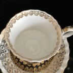 Black with heavy gold trim tea cup and saucer