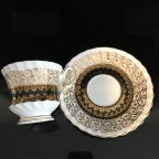 Black with heavy gold trim tea cup and saucer