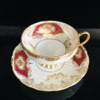 hand decorated burgundy tea cup and saucer