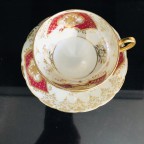 hand decorated burgundy tea cup and saucer