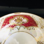 hand decorated burgundy tea cup and saucer