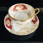 hand decorated burgundy tea cup and saucer