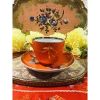 Unique bright red orange tea cup and saucer