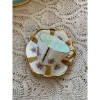 Gold striped floral tea cup and saucer